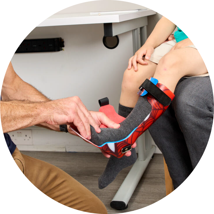 Professional applying ankle foot orthoses to a child's leg